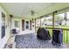 Inviting screened-in porch featuring outdoor furniture, ceiling fan, and a cozy atmosphere at 115 S Center St, Maxwell, IN 46154
