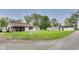 A home sits on a grassy corner lot with a utility pole and various outbuildings at 115 S Center St, Maxwell, IN 46154