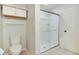 Bathroom featuring glass enclosed shower, toilet, and storage cabinet at 11614 Buttonwood Dr, Carmel, IN 46033