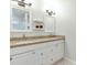 Bathroom featuring double sinks with granite countertops and bright lighting at 11614 Buttonwood Dr, Carmel, IN 46033