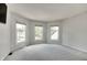 Bright bedroom with three windows offering natural light and neutral carpet at 11614 Buttonwood Dr, Carmel, IN 46033