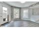 Bright breakfast nook featuring wood paneled walls, a large window and door, and gray wood-look flooring at 11614 Buttonwood Dr, Carmel, IN 46033