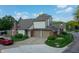 Traditional two-story home featuring a brick chimney, attached two-car garage, and manicured front lawn at 11614 Buttonwood Dr, Carmel, IN 46033