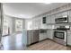 Updated kitchen featuring light blue cabinetry, stainless steel appliances, and wood look flooring at 11614 Buttonwood Dr, Carmel, IN 46033