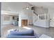 Open living space with vaulted ceiling, staircase, and views of the kitchen with blue cabinets at 11614 Buttonwood Dr, Carmel, IN 46033