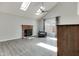 Spacious living area with vaulted ceiling, skylights, brick fireplace and neutral color palette at 11614 Buttonwood Dr, Carmel, IN 46033