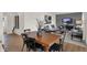 Dining area adjacent to the living room featuring a wooden table and black chairs with decor at 11929 Vale St, Indianapolis, IN 46235