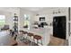 Modern kitchen with a large island, white cabinets, stainless steel appliances, and hardwood flooring at 11929 Vale St, Indianapolis, IN 46235