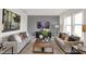 Inviting living room featuring matching sofas, a modern entertainment center, and large windows for ample natural light at 11929 Vale St, Indianapolis, IN 46235