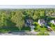 Overhead view of a brick home with a manicured lawn, mature trees, and a paved driveway in a residential neighborhood at 12065 Gray Eagle Dr, Fishers, IN 46037