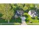 Aerial view of a well-maintained brick home with mature trees and a lush lawn in a desirable neighborhood at 12065 Gray Eagle Dr, Fishers, IN 46037