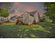 Beautiful backyard featuring a spacious lawn, mature trees, and a cozy deck, perfect for enjoying outdoor living at 12065 Gray Eagle Dr, Fishers, IN 46037