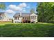 Expansive backyard featuring a wooden deck, lush green lawn, and mature trees, perfect for outdoor enjoyment at 12065 Gray Eagle Dr, Fishers, IN 46037
