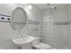 Upgraded bathroom with glass block shower, white tile, and pedestal sink at 12065 Gray Eagle Dr, Fishers, IN 46037