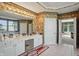 Elegant bathroom with double vanity, large mirror, and doorway to bedroom, enhancing a luxurious Primary suite at 12065 Gray Eagle Dr, Fishers, IN 46037