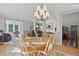 Bright dining room with hardwood floors, a chandelier, and seamless flow to other living spaces at 12065 Gray Eagle Dr, Fishers, IN 46037