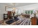 Open-concept dining area with wood table, hardwood floors, and an elegant chandelier at 12065 Gray Eagle Dr, Fishers, IN 46037