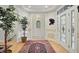 Spacious foyer with hardwood floors, elegant rug, and decorative accents providing a warm welcome at 12065 Gray Eagle Dr, Fishers, IN 46037