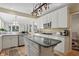 Bright kitchen with stainless steel appliances, white cabinetry, and a center island with granite countertop at 12065 Gray Eagle Dr, Fishers, IN 46037