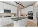 Stylish kitchen with white cabinetry, center island, stainless appliances, and efficient layout for cooking and dining at 12065 Gray Eagle Dr, Fishers, IN 46037