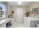 Well-equipped laundry room with modern machines, a folding table, and bright natural light at 12065 Gray Eagle Dr, Fishers, IN 46037