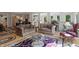 Comfortable living room with hardwood floors, a floral rug, and an open layout to the dining area at 12065 Gray Eagle Dr, Fishers, IN 46037