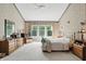 Spacious primary bedroom with large windows and ensuite bathroom with vanity and storage at 12065 Gray Eagle Dr, Fishers, IN 46037
