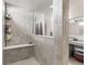Modern bathroom showcasing a large tiled shower with bench and a granite countertop vanity with double sinks at 1289 Sunset Blvd, Avon, IN 46123