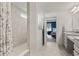 Bright bathroom featuring tiled walk-in shower with curtain and access to the main bedroom with a dark accent wall at 1289 Sunset Blvd, Avon, IN 46123
