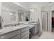Bathroom with granite countertops, double sinks, a large mirror, and a tiled walk-in shower with glass door at 1289 Sunset Blvd, Avon, IN 46123
