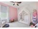 Pink accent wall highlights this bedroom featuring a canopy bed, soft chair, and bright, natural light at 1289 Sunset Blvd, Avon, IN 46123