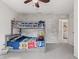 Bedroom featuring a gray bunk bed, brick accent wall, and a doorway to the laundry room at 1289 Sunset Blvd, Avon, IN 46123