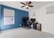 Bedroom featuring a blue accent wall with a desk and modern fixtures at 1289 Sunset Blvd, Avon, IN 46123