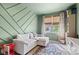 Versatile bonus room with custom wall paneling, a cozy sofa, and ample natural light at 1289 Sunset Blvd, Avon, IN 46123
