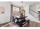 Cozy dining area with wooden table and bench seating beneath a stylish woven light fixture and next to a staircase at 1289 Sunset Blvd, Avon, IN 46123