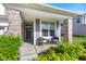 Inviting covered front porch with stone columns and a cozy seating area at 1289 Sunset Blvd, Avon, IN 46123