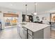 A shot from the kitchen featuring a kitchen island, stainless steel appliances, and an open living area at 1289 Sunset Blvd, Avon, IN 46123