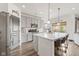 Well-lit kitchen featuring a large center island, gray cabinets, stainless steel appliances, and a view to the backyard at 1289 Sunset Blvd, Avon, IN 46123