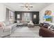 Spacious living room with comfortable sectional sofa, ceiling fan, and neutral decor, perfect for relaxation and entertaining at 1289 Sunset Blvd, Avon, IN 46123