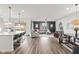 Bright, open-concept living area with hardwood floors and stylish modern furnishings and kitchen featuring a large island at 1289 Sunset Blvd, Avon, IN 46123