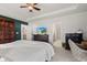 Comfortable main bedroom featuring a tray ceiling, a ceiling fan, and a dresser with a TV screen at 1289 Sunset Blvd, Avon, IN 46123