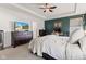 Spacious main bedroom features a dresser with a TV, a ceiling fan, and an accent wall with a desk area at 1289 Sunset Blvd, Avon, IN 46123