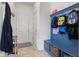 Mudroom area featuring a built-in bench with storage baskets and wall-mounted hooks, with access to the front door at 1289 Sunset Blvd, Avon, IN 46123
