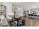 A view of the dining area table leading into a kitchen featuring gray cabinets and a kitchen island with barstool seating at 1289 Sunset Blvd, Avon, IN 46123