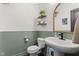 Stylish powder room with two-tone walls, floating shelves, and a modern vessel sink at 1289 Sunset Blvd, Avon, IN 46123