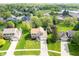A front aerial view of a 2-story home with a large yard, mature trees, and an attached two car garage at 13131 Conner Knoll Pkwy, Fishers, IN 46038