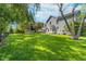 A large backyard with mature trees, lush green lawn, patio and playset, perfect for outdoor entertaining at 13131 Conner Knoll Pkwy, Fishers, IN 46038