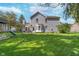 A sprawling backyard with mature trees, lush green lawn, patio and playset, perfect for outdoor entertaining at 13131 Conner Knoll Pkwy, Fishers, IN 46038
