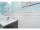 Half bathroom with wainscoting, round mirror, and modern fixtures at 13131 Conner Knoll Pkwy, Fishers, IN 46038