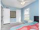 Cozy bedroom with a large window, ceiling fan, and calming color scheme at 13131 Conner Knoll Pkwy, Fishers, IN 46038